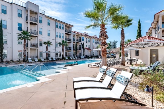 Swimming pool deck with palm trees  at Two Addison Place Apartments , Pooler, GA
