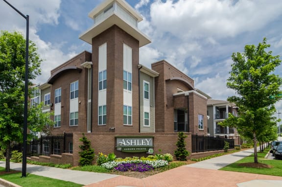 Brick Sign Main Entrance Main property entrance with brick sign and floral arrangement at Ashley Aburn Pointe in Atlanta, GA