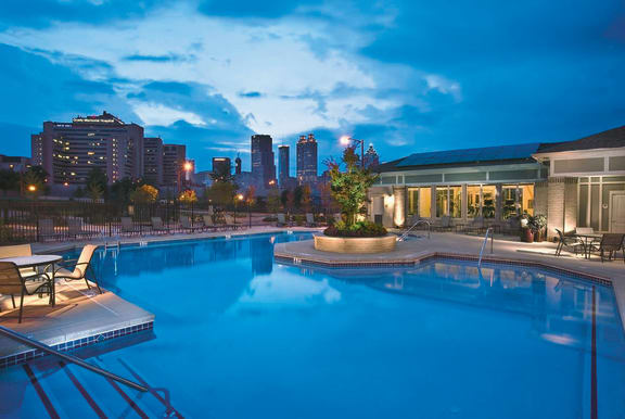 Nighttime view of Community Pool Nighttime view of community pool with Atlanta skyline in background at Ashley at Auburn Pointe in Atlanta, GA