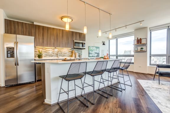 Hubbard Place apartment kitchen with large windows and island in River North Chicago