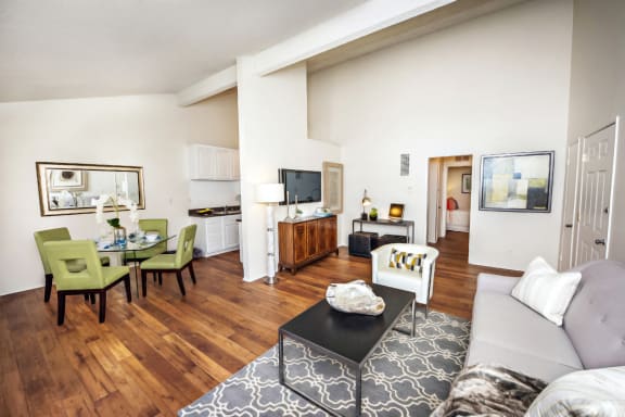 Oakview upstairs unit has vaulted ceilings with a living area to the right and dining area to the left, opposite the kitchen. This unit has wood style flooring.