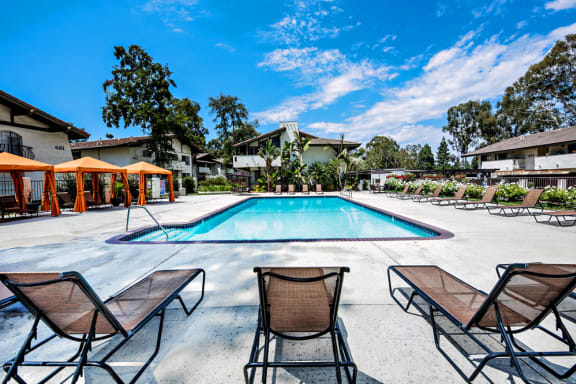 Oakview main swimming pool is a large pool by the leasing office. The pool area has cabanas with seating areas, chaise lounges and umbrellas and surrounded by lush greenery
