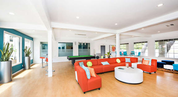The recreation room has a large orange fabric circular sofa with TV and coffee table. Large windows creates a bright and airy room. A large walled scrabble board, pool table with free WIFI.