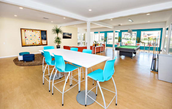 The recreation room has a large orange fabric circular sofa with TV and coffee table. Large windows creates a bright and airy room. A large walled scrabble board, pool table with free WIFI.