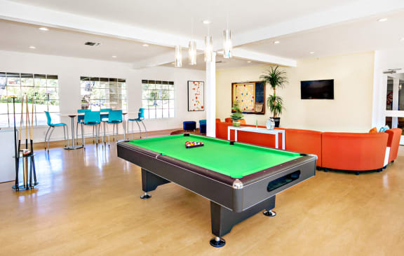 The recreation room has a large orange fabric circular sofa with TV and coffee table. Large windows creates a bright and airy room. A large walled scrabble board, pool table with free WIFI.