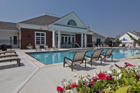 Pool and chairs behind clubhouse