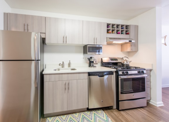 Upgraded fully-equipped kitchen with stainless steel appliances and wood flooring at Amberleigh apartments in Fairfax, Virginia 22031
