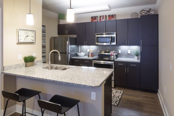 Ascent 430 kitchen equipped with modern stainless steel appliances and granite counter tops