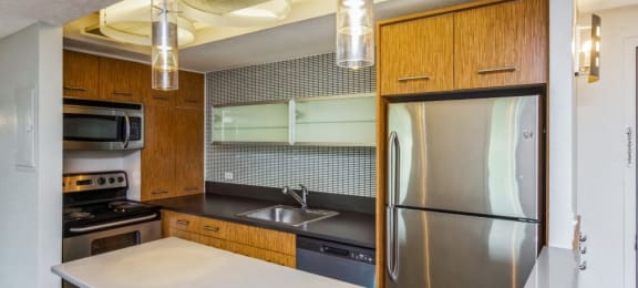 Kitchen with stainless steel appliances and a breakfast bar