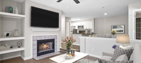 Renovated Sunken living room with a fireplace and a ceiling fan