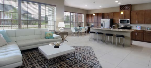 Luxury apartments with spacious open floor plan, granite countertops, stainless steel appliances, built-in wine rack, kitchen island, and porcelain tile floor at Bellemeade Apartments in west Des Moines