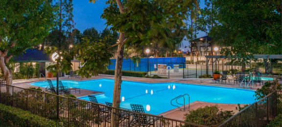 Evening pool view with lounge chairs Grand on Lindley 1 and 2 bedroom apts for rent in northridge ca