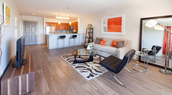 View of the living room and kitchen in the model apartment at Munroe Place in Quincy