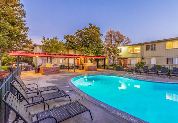 Pool with lounge chairs l Cottage Bell Apartments in Sacramento CA