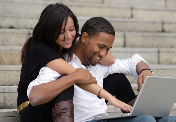 Couple browsing laptop