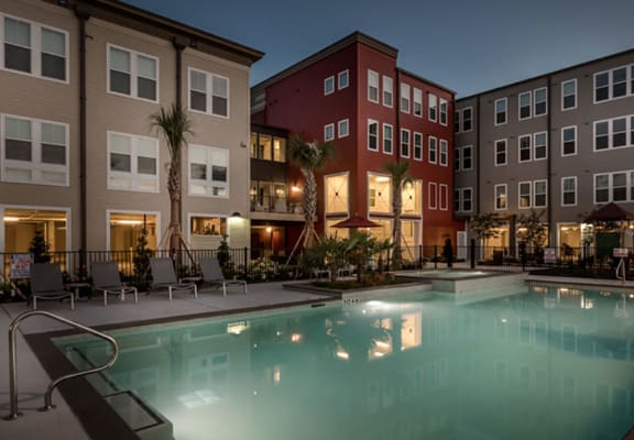 Outdoor swimming pool and pool area during dusk-Villas on the Strand, Galveston, TX 77550