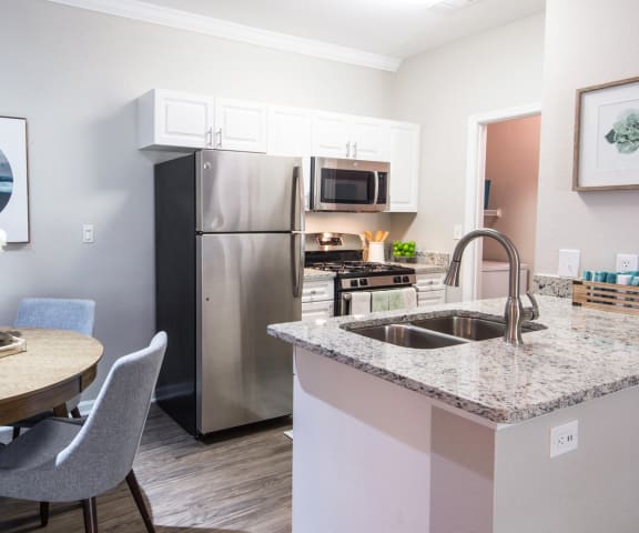Fully Equipped Kitchens And Dining at Riverstone at Owings Mills Apartments, Owings Mills