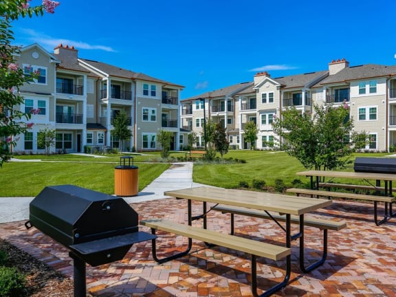 Thumbnail 13 of 39 - Outdoor Gathering Space with BBQ Grills and Outdoor Seating at Oasis Shingle Creek in Kissimmee, FL