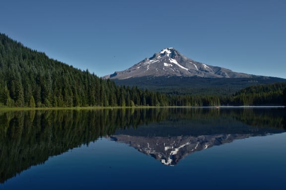 Photo of a lake near Mount Hood with Mount Hood in the background and reflected in the lake.