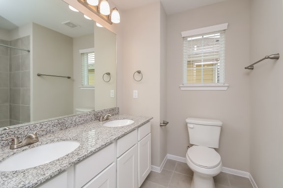 Primary bathroom with granite countertops Primary bathroom with granite countertops at Pradera Oaks, Texas, 77583