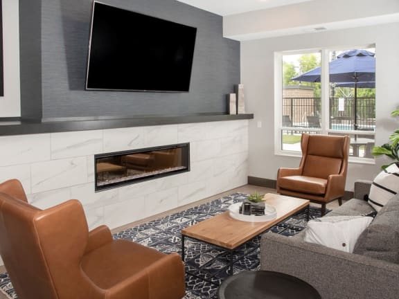 Community room lounge with fire place and tv at Urban Park I and II Apartments, Minnesota, 55426