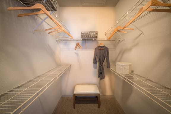 This is a photo of the walk-in closet in th 826 square foot 1 bedroom  apartment at The Brownstones Townhome Apartments in Dallas, TX.