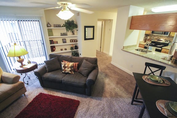 This is a photo of the living room in the 692 square foot 1 bedroom model apartment at Cambridge Court Apartments in Dallas, TX.