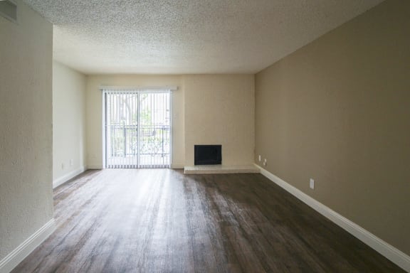 This is a photo of the living room with fireplace of the 880 square foot 2 bedroom apartment at Canyon Creek Apartments in Dallas, TX