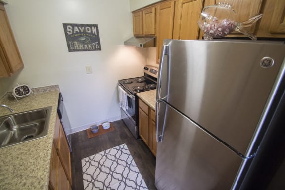 This is a kitchen with stainless steel appliances at Deer HIll Apartments in Cincinnati, OH.