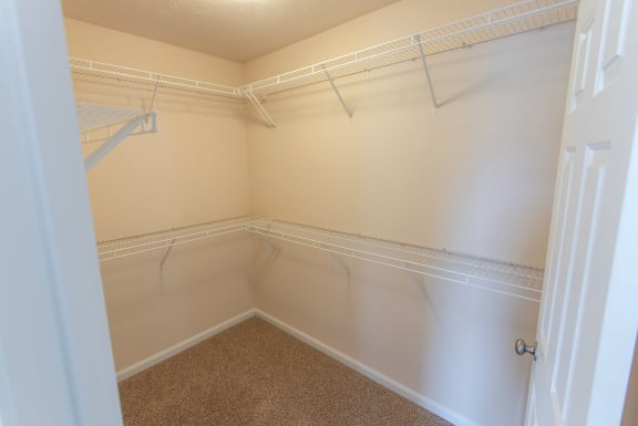 This is a photo of the master bedroom walk-in closet in the 1578 square foot, 3 bedroom Flagship floor plan at Nantucket Apartments in Loveland, OH.