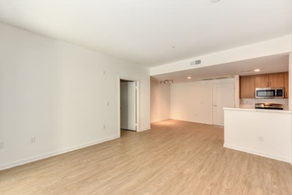 Vacant home with white painted walls and hardwood inspired flooring through out the home.