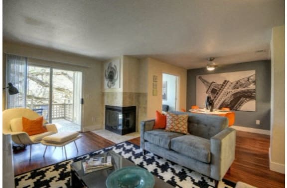 Living Room with Fireplace Hardwood Inspired Floors and Private Patio