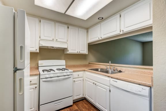 Timeless Kitchens featuring white cabinets and appliances.