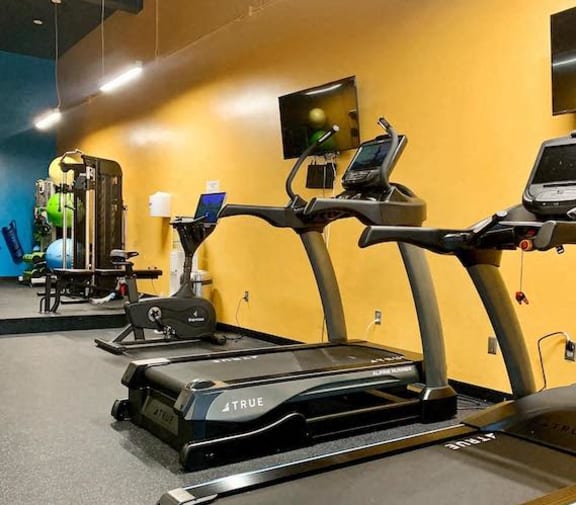 Renovated fitness center with new equipment and bright colors at Jemison Flats, Birmingham, AL, 35203