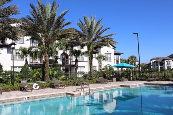 stunning resort inspired beach-style pool and sundeck at Lake Nona Water Mark Apartments in Orlando, FL