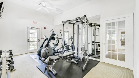 Fitness Center with Exercise Equipment, Mirrored Wall  and Mounted TV
