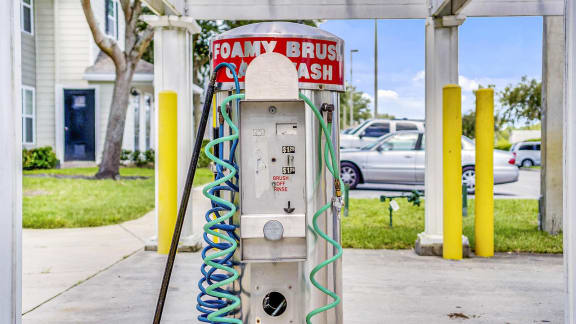 Car Wash Machine with Car Wash Station and Parking Lot in the Background