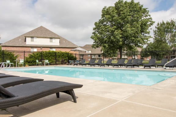 Pool with lounge chairs at Fountain Glen Apartments!