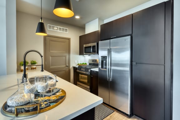 Modern kitchen with stainless steel appliances at Cuvee Apartments, Arizona