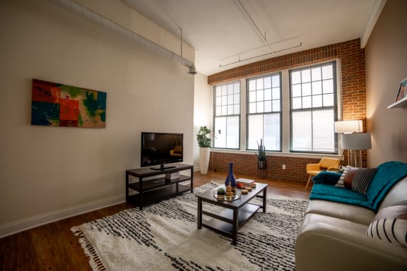 Living Room With TV at Harness Factory Lofts, Managed by Buckingham Urban Living, Indiana, 46204