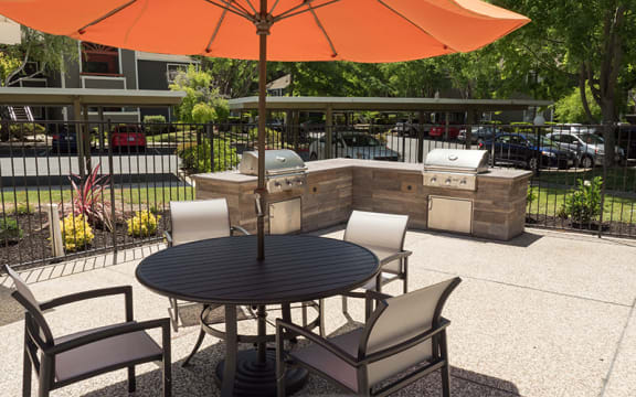 Seating by BBQ area  l Waterford Cove Apartments in Sacramento CA