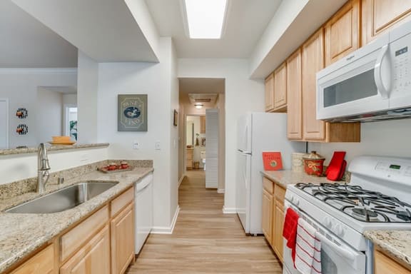 Kitchen with appliances and wood floors | Bella Rose Apartments in Antioch, CA 94531