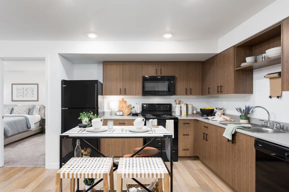 a kitchen in a 555 waverly unit with a table and two stools in the