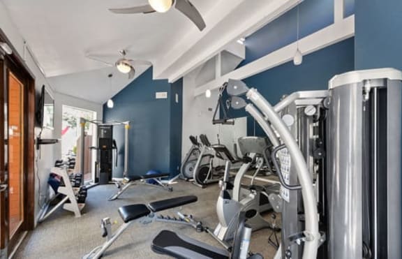 Gym with cardio equipment l The Enclave in Paramount CA