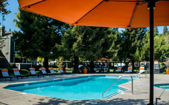 Pool with lounge chairs  l Waterford Cove Apartments in Sacramento CA