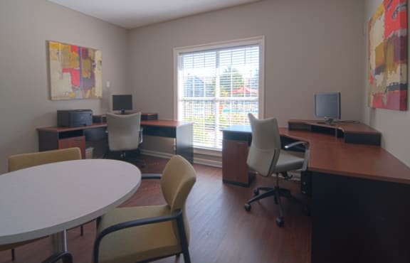 a room with a table and chairs and a large window