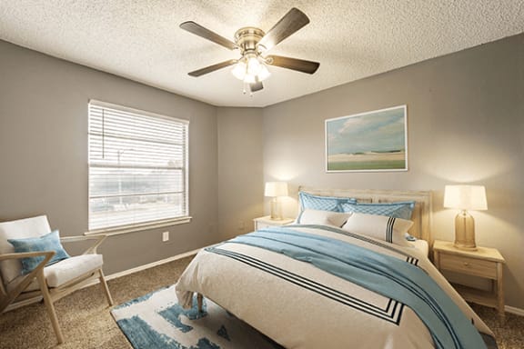 a bedroom with a ceiling fan