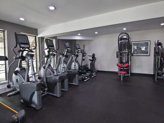 Spacious fitness center with cardio and weightlifting equipment at Camelot East Apartments in Fairfield, OH 45014
