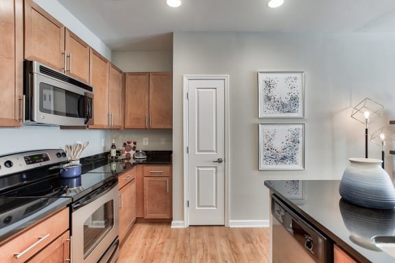 Stainless Steel Appliances And Wood Cabinetry in Kitchens at The Ridgewood by Windsor, Fairfax, Virginia