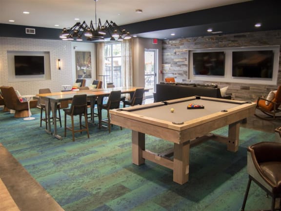 a recreation room with a pool table and a foosball table